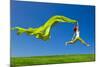 Beautiful Young Woman Jumping On A Green Meadow With A Colored Tissue-iko-Mounted Photographic Print