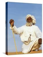 Bedouin Man Kneels on Top of a Sand Dune in the Desert-John Warburton-lee-Stretched Canvas