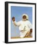 Bedouin Man Kneels on Top of a Sand Dune in the Desert-John Warburton-lee-Framed Photographic Print