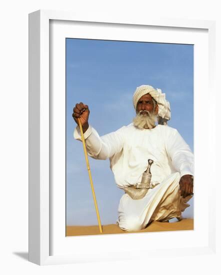 Bedouin Man Kneels on Top of a Sand Dune in the Desert-John Warburton-lee-Framed Photographic Print