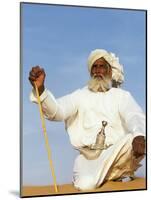 Bedouin Man Kneels on Top of a Sand Dune in the Desert-John Warburton-lee-Mounted Photographic Print