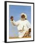 Bedouin Man Kneels on Top of a Sand Dune in the Desert-John Warburton-lee-Framed Photographic Print