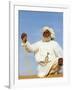 Bedouin Man Kneels on Top of a Sand Dune in the Desert-John Warburton-lee-Framed Photographic Print