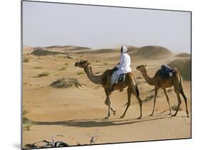 Bedu Rides His Camel Amongst the Sand Dunes in the Desert-John Warburton-lee-Mounted Photographic Print