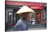 Beijing, China. Old Man with Conical Hat Passing in Front of a Shop in a Hutong of Beijing-Matteo Colombo-Stretched Canvas