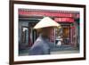 Beijing, China. Old Man with Conical Hat Passing in Front of a Shop in a Hutong of Beijing-Matteo Colombo-Framed Photographic Print