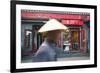 Beijing, China. Old Man with Conical Hat Passing in Front of a Shop in a Hutong of Beijing-Matteo Colombo-Framed Photographic Print