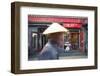 Beijing, China. Old Man with Conical Hat Passing in Front of a Shop in a Hutong of Beijing-Matteo Colombo-Framed Photographic Print