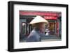 Beijing, China. Old Man with Conical Hat Passing in Front of a Shop in a Hutong of Beijing-Matteo Colombo-Framed Photographic Print