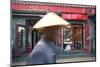 Beijing, China. Old Man with Conical Hat Passing in Front of a Shop in a Hutong of Beijing-Matteo Colombo-Mounted Photographic Print