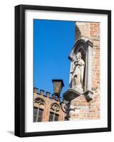 Belgium, Brugge. A stone statue on the cornerstone of a building.-Julie Eggers-Framed Photographic Print