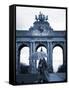 Belgium, Brussels; a Girl Walking with an Umbrella in Front of the Arc Du Triomphe-Ken Sciclina-Framed Stretched Canvas