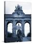 Belgium, Brussels; a Girl Walking with an Umbrella in Front of the Arc Du Triomphe-Ken Sciclina-Stretched Canvas