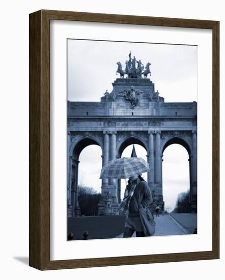 Belgium, Brussels; a Girl Walking with an Umbrella in Front of the Arc Du Triomphe-Ken Sciclina-Framed Photographic Print