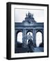 Belgium, Brussels; a Girl Walking with an Umbrella in Front of the Arc Du Triomphe-Ken Sciclina-Framed Photographic Print