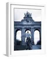 Belgium, Brussels; a Girl Walking with an Umbrella in Front of the Arc Du Triomphe-Ken Sciclina-Framed Photographic Print