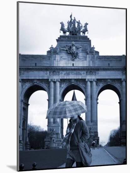 Belgium, Brussels; a Girl Walking with an Umbrella in Front of the Arc Du Triomphe-Ken Sciclina-Mounted Photographic Print