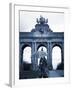 Belgium, Brussels; a Girl Walking with an Umbrella in Front of the Arc Du Triomphe-Ken Sciclina-Framed Photographic Print