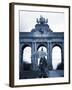 Belgium, Brussels; a Girl Walking with an Umbrella in Front of the Arc Du Triomphe-Ken Sciclina-Framed Photographic Print