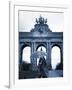 Belgium, Brussels; a Girl Walking with an Umbrella in Front of the Arc Du Triomphe-Ken Sciclina-Framed Photographic Print