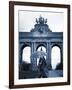 Belgium, Brussels; a Girl Walking with an Umbrella in Front of the Arc Du Triomphe-Ken Sciclina-Framed Photographic Print