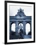 Belgium, Brussels; a Girl Walking with an Umbrella in Front of the Arc Du Triomphe-Ken Sciclina-Framed Photographic Print