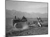 Benji Iguchi driving a tractor, Manzanar Relocation Center, California, 1943-Ansel Adams-Mounted Photographic Print