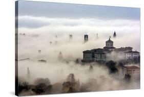 Bergamo, Lombardy, Italy. Foggy sunrise over high city.-ClickAlps-Stretched Canvas