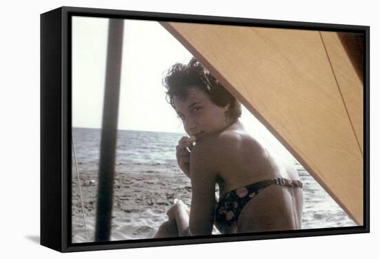 Bernadette Lafont, as a young woman, on the beach, south of France, c. 1955 (photo)-null-Framed Stretched Canvas