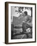 Betty Jane Baldwin Sitting on Fence and Looking at Official Board at Warrenton Horse Show-Martha Holmes-Framed Photographic Print