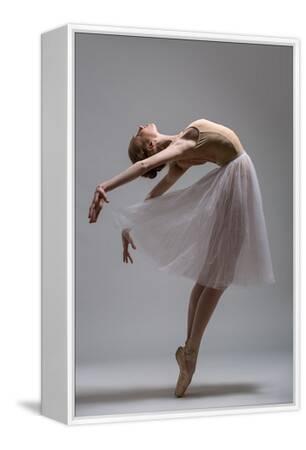Graceful Ballerina Standing on Toes Bending the Back. Studio Shot