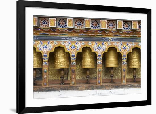 Bhutan. Spinning prayer wheels along a temple wall.-Brenda Tharp-Framed Premium Photographic Print