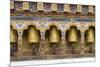 Bhutan. Spinning prayer wheels along a temple wall.-Brenda Tharp-Mounted Premium Photographic Print