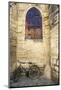 Bicycle Against Medieval Stone Church and Window in France-Sheila Haddad-Mounted Photographic Print