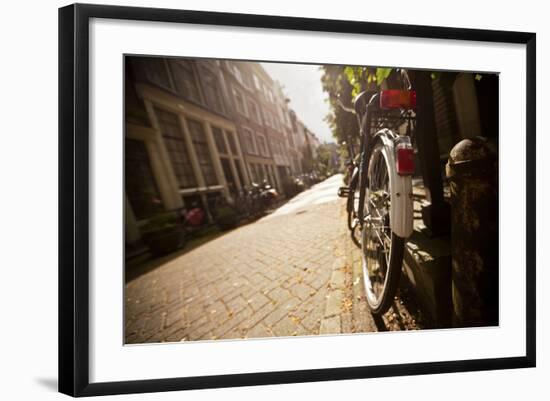 Bicycle in an Alley Street in Amsterdam, Netherlands-Carlo Acenas-Framed Photographic Print