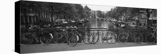 Bicycle Leaning Against a Metal Railing on a Bridge, Amsterdam, Netherlands-null-Stretched Canvas
