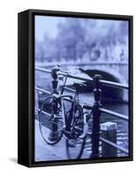 Bicycle on Rail by Canal, Amsterdam, Netherlands-Walter Bibikow-Framed Stretched Canvas