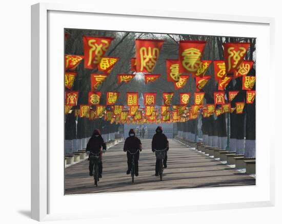 Bicycle Riders at Entranceway to Festival, Ice and Snow Festival, Harbin, Heilongjiang, China-Walter Bibikow-Framed Photographic Print