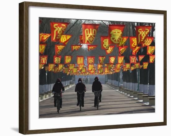 Bicycle Riders at Entranceway to Festival, Ice and Snow Festival, Harbin, Heilongjiang, China-Walter Bibikow-Framed Photographic Print