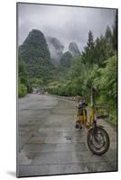 Bicycle sits in front of the Guilin Mountains, Guilin, Yangshuo, China-Josh Anon-Mounted Photographic Print