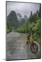 Bicycle sits in front of the Guilin Mountains, Guilin, Yangshuo, China-Josh Anon-Mounted Photographic Print