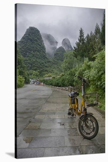 Bicycle sits in front of the Guilin Mountains, Guilin, Yangshuo, China-Josh Anon-Stretched Canvas