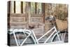 Bicycle with a Basket of a Dried Bouquet Flower Stand in Front of Wooden and Rustic House Backgroun-WichitS-Stretched Canvas