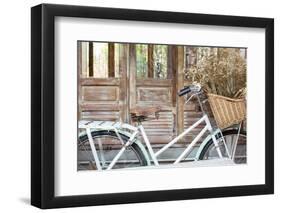 Bicycle with a Basket of a Dried Bouquet Flower Stand in Front of Wooden and Rustic House Backgroun-WichitS-Framed Photographic Print