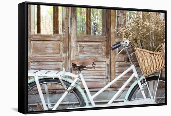 Bicycle with a Basket of a Dried Bouquet Flower Stand in Front of Wooden and Rustic House Backgroun-WichitS-Framed Stretched Canvas