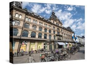 Bicycles parked in front of the Magasin du Nord department store, Copenhagen, Denmark, Scandinavia-Jean Brooks-Stretched Canvas