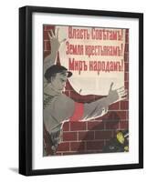 Big Brave Communist Worker Fixes a Poster on a Wall-null-Framed Photographic Print