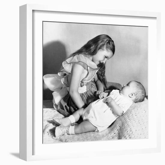 Big Sister Looks Down on Her Baby Brother, Ca. 1948-null-Framed Photographic Print