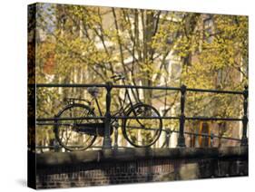 Bike on Bridge, Amsterdam, Holland-Alan Copson-Stretched Canvas