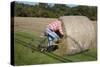 Bike Riding into Hay Bail-null-Stretched Canvas